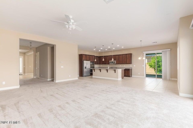 unfurnished living room with light carpet, ceiling fan, recessed lighting, and baseboards