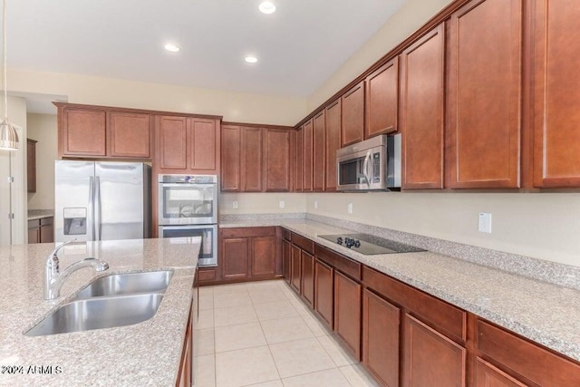 kitchen featuring light tile patterned floors, sink, stainless steel appliances, and light stone counters