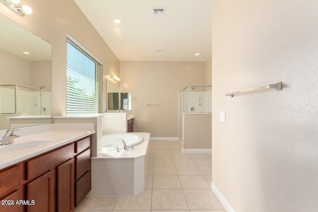 full bath with two vanities, a sink, tile patterned flooring, a shower stall, and a bath