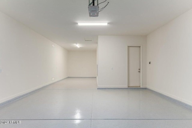 garage featuring baseboards and a garage door opener