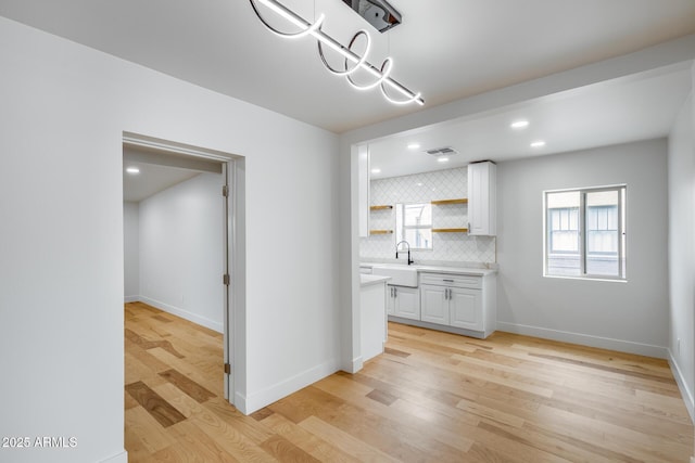 unfurnished dining area featuring visible vents, baseboards, recessed lighting, and light wood-style floors
