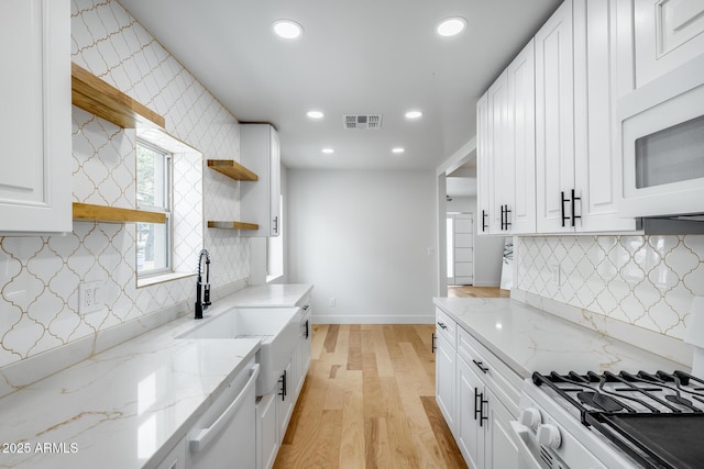 kitchen featuring visible vents, open shelves, light wood-type flooring, white appliances, and recessed lighting