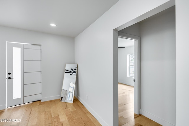 entrance foyer with recessed lighting, light wood-style floors, and baseboards