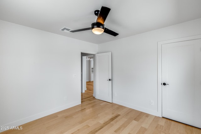 unfurnished bedroom with light wood-style floors, baseboards, a ceiling fan, and visible vents