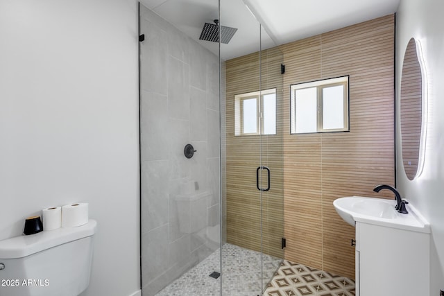 full bath with tile patterned flooring, a shower stall, toilet, and vanity