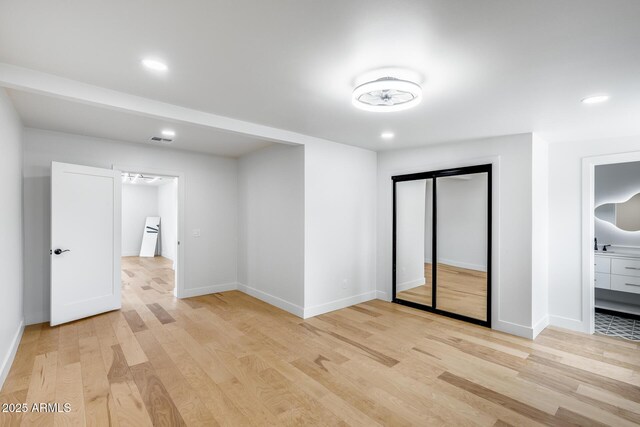 unfurnished bedroom featuring baseboards, recessed lighting, visible vents, and light wood-type flooring