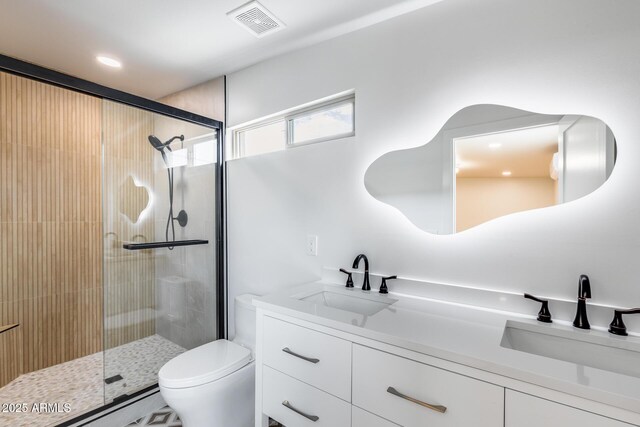 bathroom featuring visible vents, toilet, a stall shower, and vanity