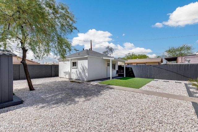 back of house featuring a patio, a fenced backyard, and stucco siding
