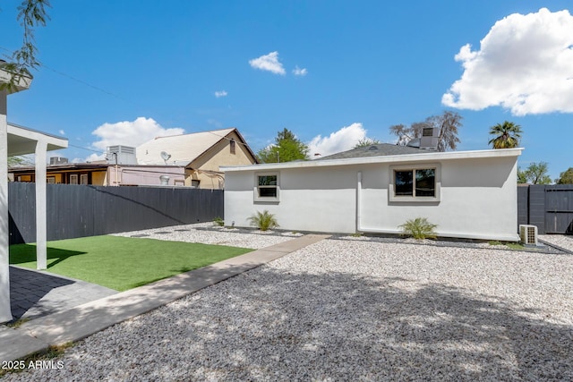 back of house with a patio area, fence, a lawn, and stucco siding