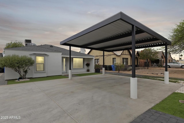 exterior space featuring stucco siding, driveway, and a carport
