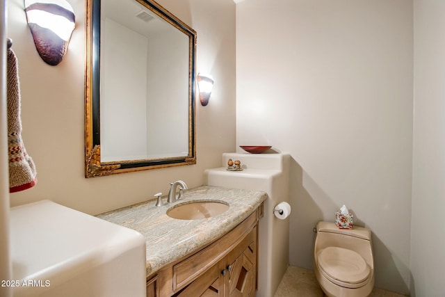 bathroom with vanity and toilet