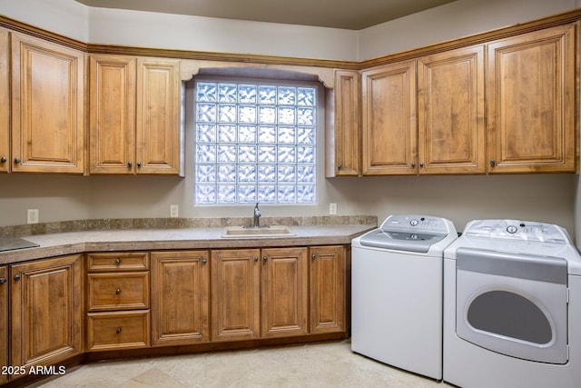 washroom with separate washer and dryer, sink, and cabinets