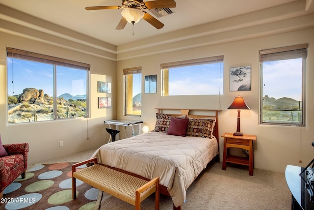 carpeted bedroom featuring multiple windows and a mountain view