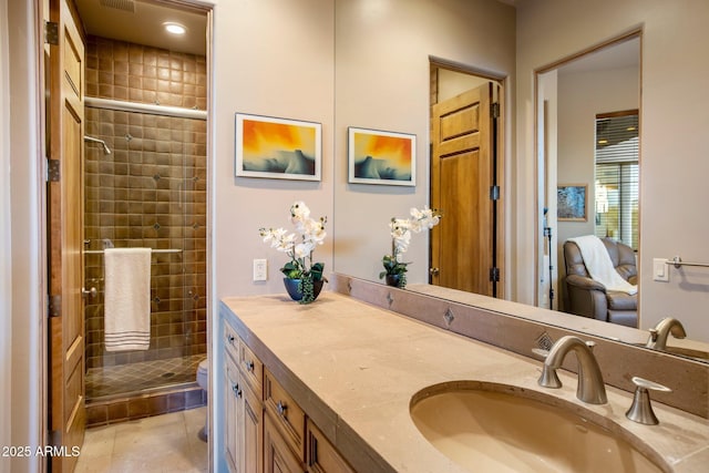 bathroom featuring vanity, toilet, and walk in shower