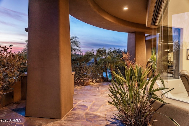 view of patio terrace at dusk