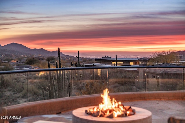 balcony at dusk with a mountain view and a fire pit