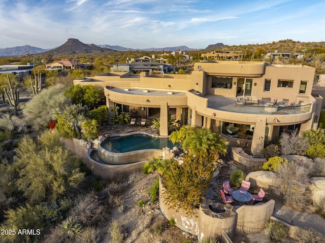 back of house with a mountain view