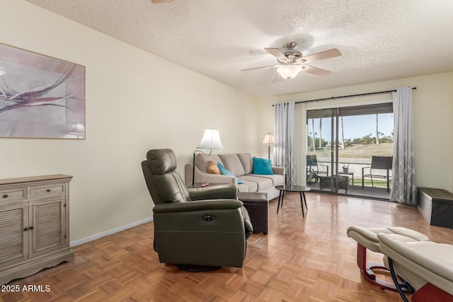 living room with a textured ceiling, parquet floors, and ceiling fan