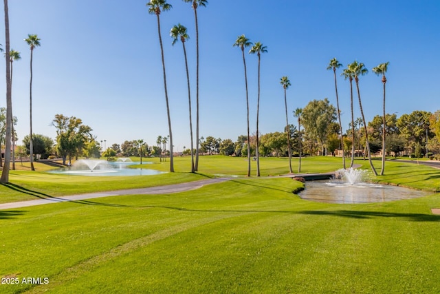 view of home's community with a yard and a water view