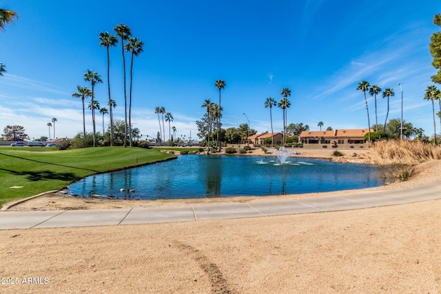 view of pool with a yard and a water view