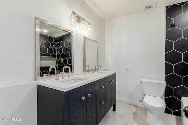 bathroom with visible vents, a sink, double vanity, and toilet