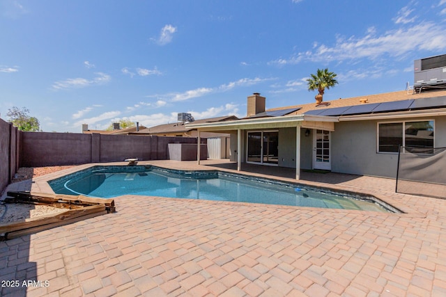 view of pool featuring a patio, a fenced backyard, a fenced in pool, and central AC unit