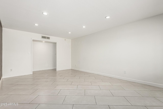 empty room featuring recessed lighting, baseboards, and visible vents