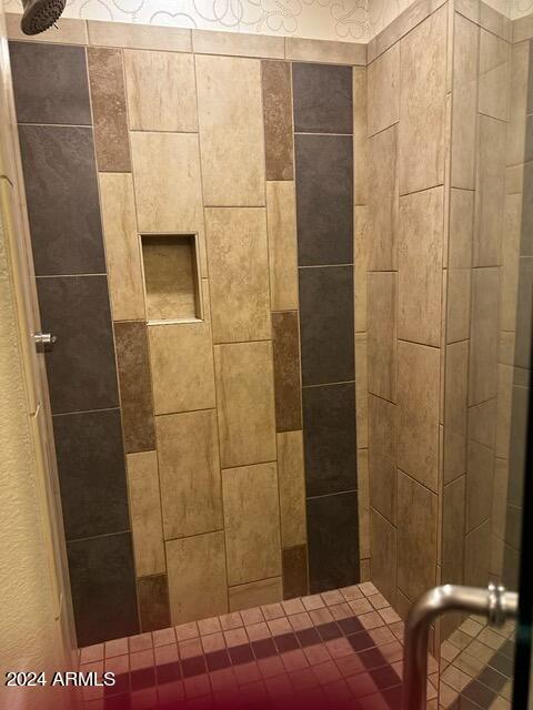 bathroom with a tile shower