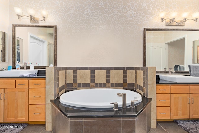 bathroom featuring tile patterned floors, tiled bath, and vanity