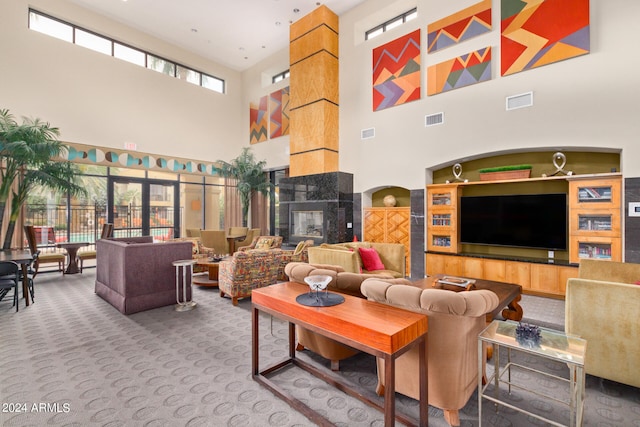 interior space with a high ceiling and a tiled fireplace