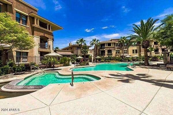 view of pool featuring a hot tub and a patio area