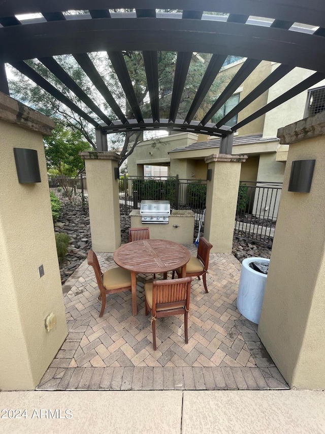 view of patio / terrace with a pergola and area for grilling