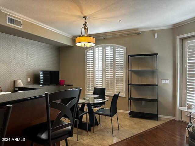 office featuring light hardwood / wood-style floors and crown molding