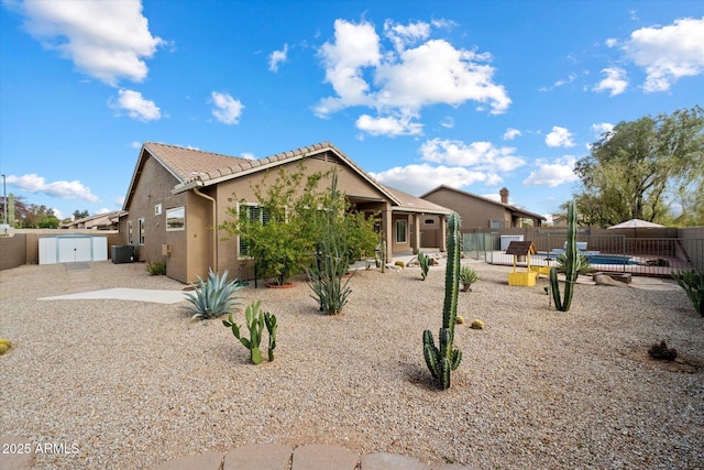 5005 E Baker Dr, Cave Creek, AZ 85331 - view of front facade featuring stucco siding, a shed, a tiled roof, central AC unit, and a patio area