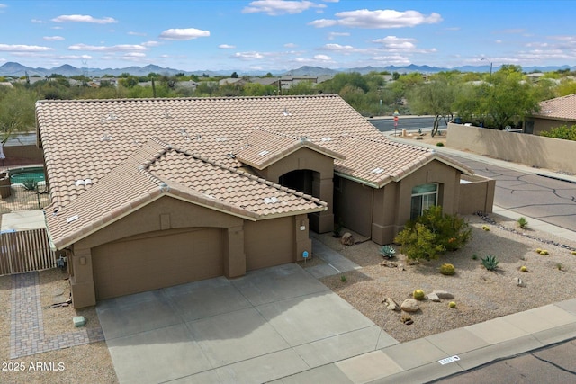 5005 E Baker Dr, Cave Creek, AZ 85331 - ranch-style house featuring a tile roof, stucco siding, fence, a mountain view, and a garage