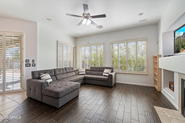 5005 E Baker Dr, Cave Creek, AZ 85331 - living area featuring wood tiled floor, a fireplace with flush hearth, ceiling fan, and visible vents