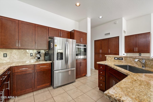 5005 E Baker Dr, Cave Creek, AZ 85331 - kitchen featuring tasteful backsplash, a sink, visible vents, light stone countertops, and appliances with stainless steel finishes