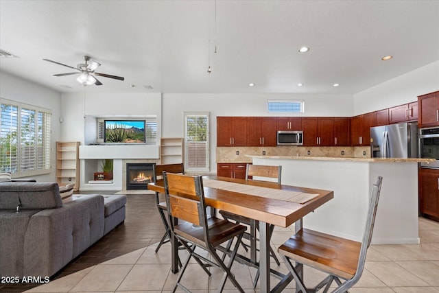 5005 E Baker Dr, Cave Creek, AZ 85331 - dining space featuring a tiled fireplace, visible vents, ceiling fan, and a wealth of natural light