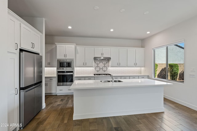 kitchen with a center island with sink, white cabinets, appliances with stainless steel finishes, and dark hardwood / wood-style flooring