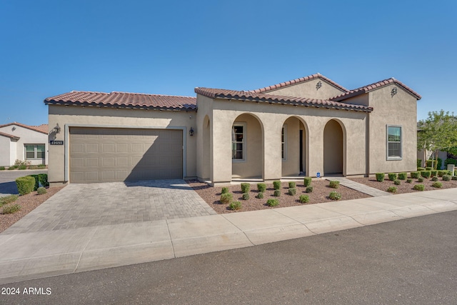 mediterranean / spanish home with a garage