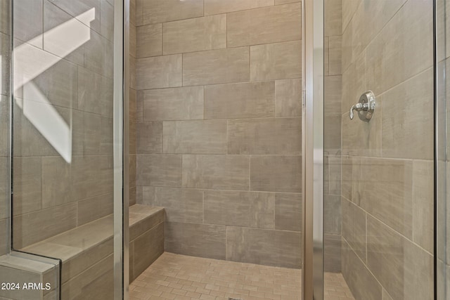 bathroom featuring a shower with door