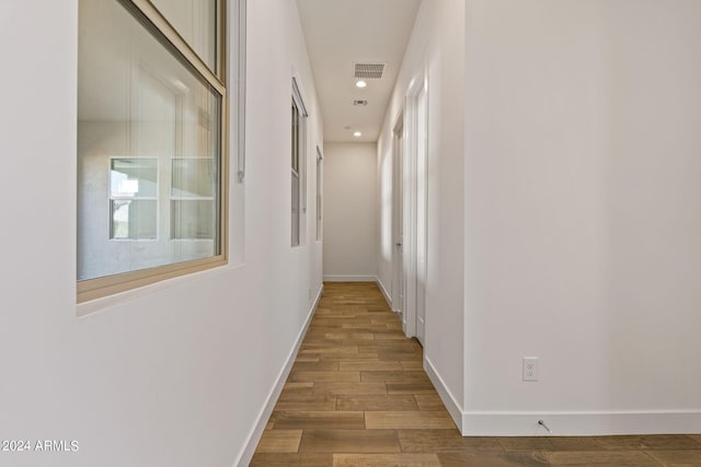 hallway with wood-type flooring