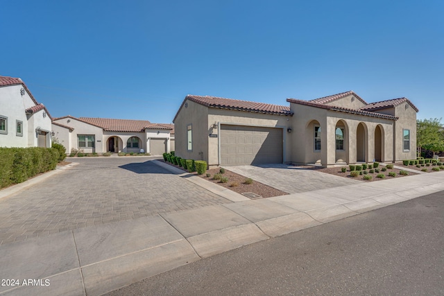 mediterranean / spanish home with a garage