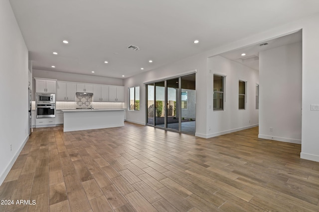 unfurnished living room with light hardwood / wood-style floors