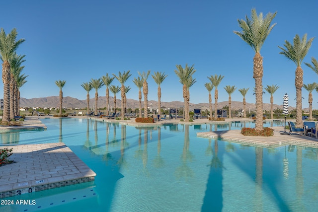 view of pool with a mountain view and a patio