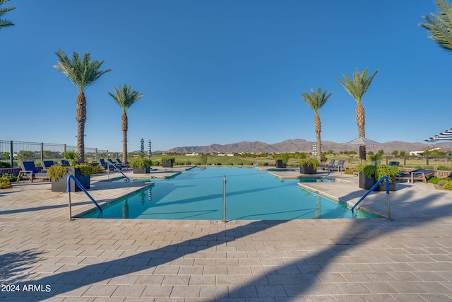 view of pool with a mountain view and a patio