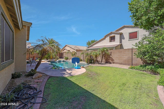 view of yard featuring a patio and a fenced in pool