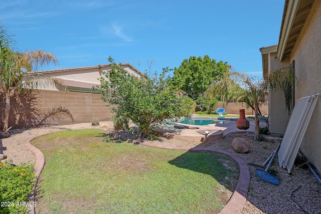 view of yard featuring a patio and a fenced in pool