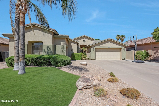 view of front of house with a front yard and a garage