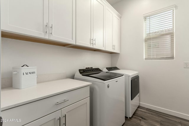 clothes washing area featuring cabinets, dark hardwood / wood-style floors, and washing machine and clothes dryer